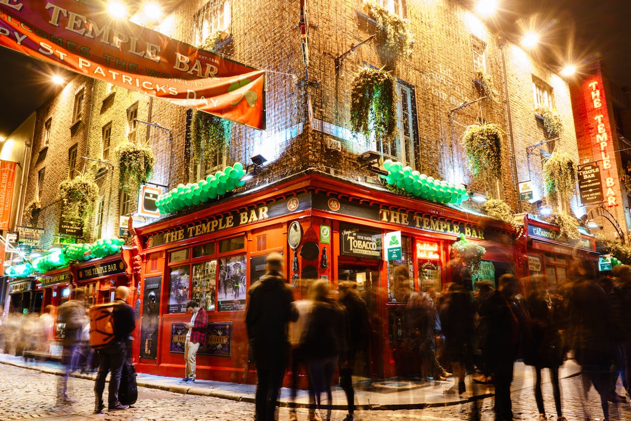 People in front of a Lighted Building