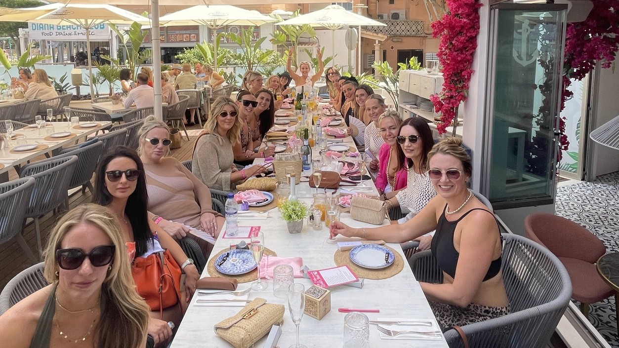 bride to be and party sitting at a long table
